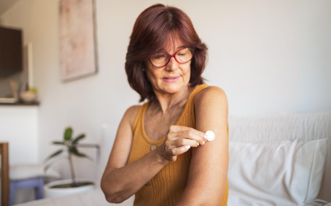 A woman in her early 60's applying hormone replacement therapy into her left arm